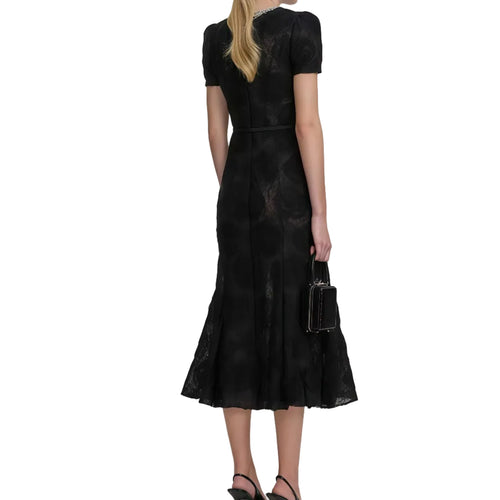 Woman wearing a black lace dress on a white background