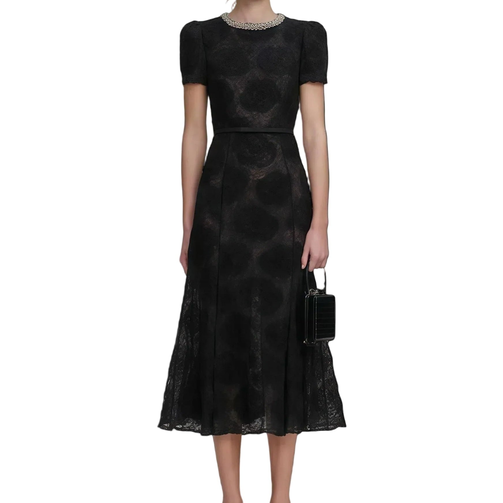 Woman wearing a black patterned dress on a white background