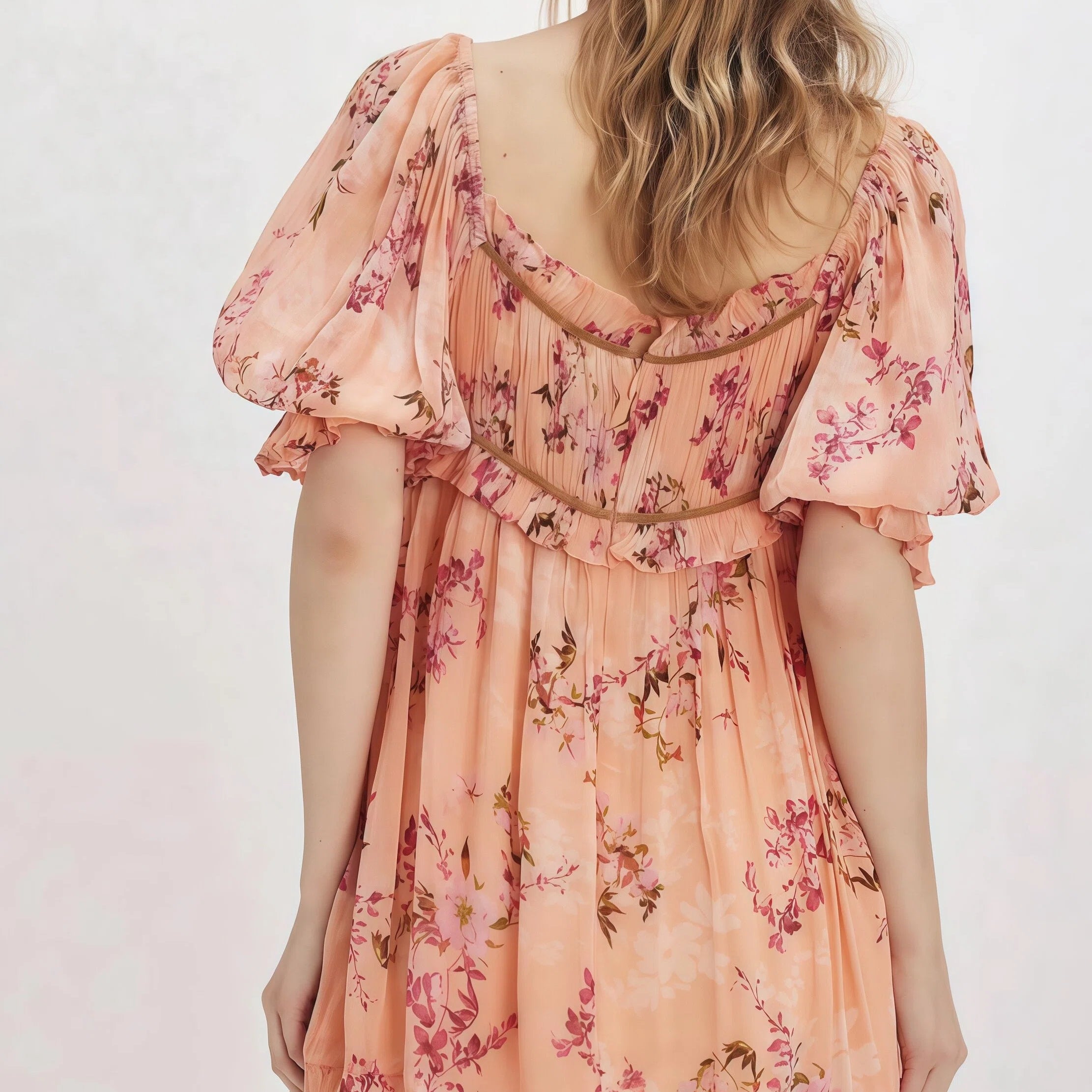 Woman wearing a floral dress with a plain background