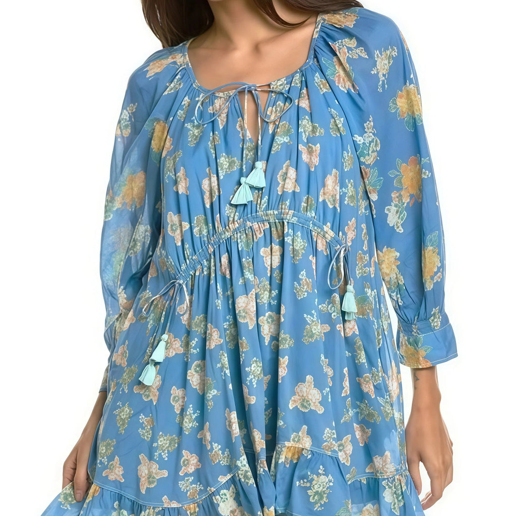 Woman wearing a blue floral dress on a white background