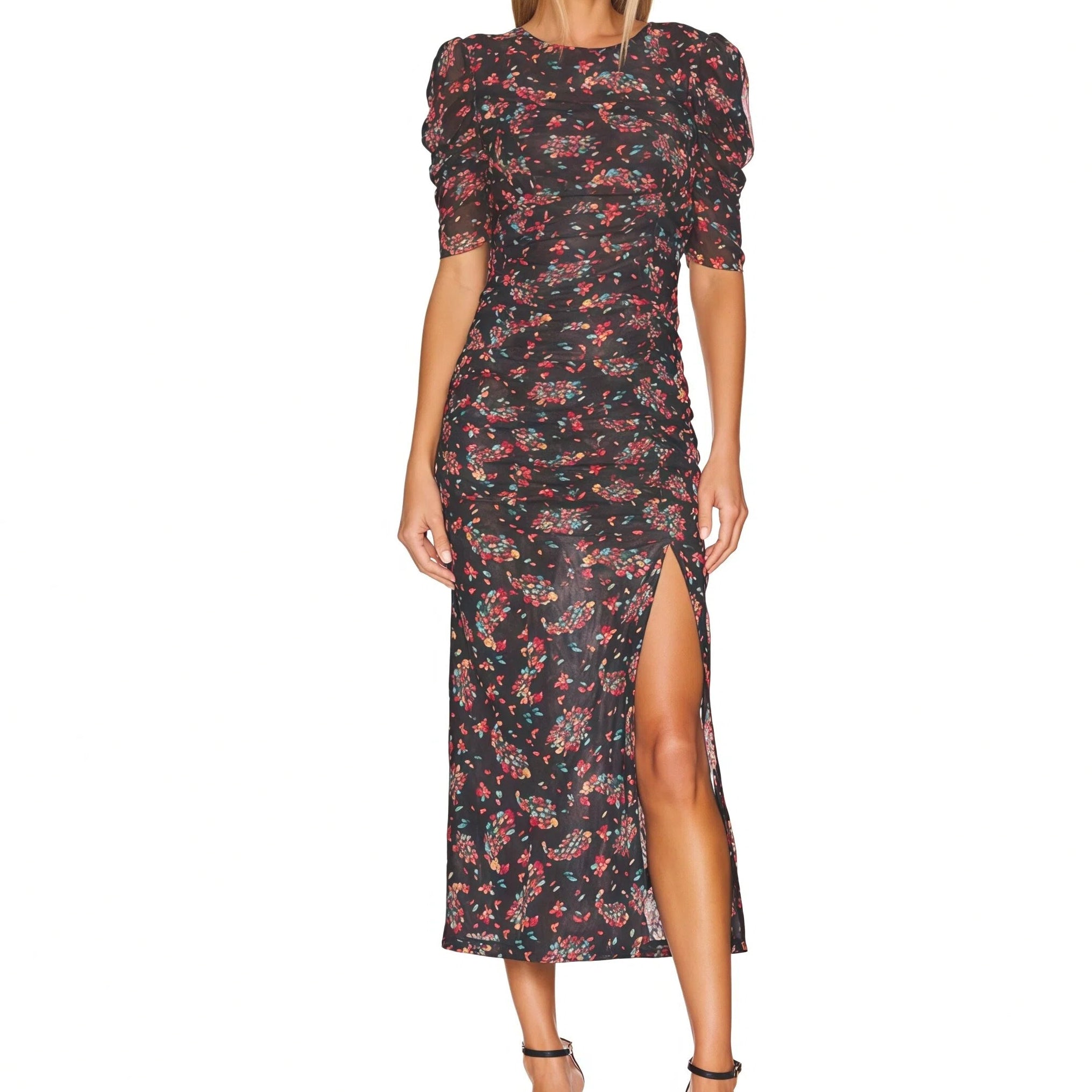Woman wearing a floral dress with a slit on a white background