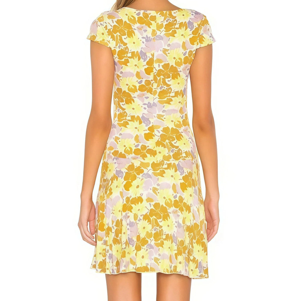 Woman wearing a yellow floral dress on a white background