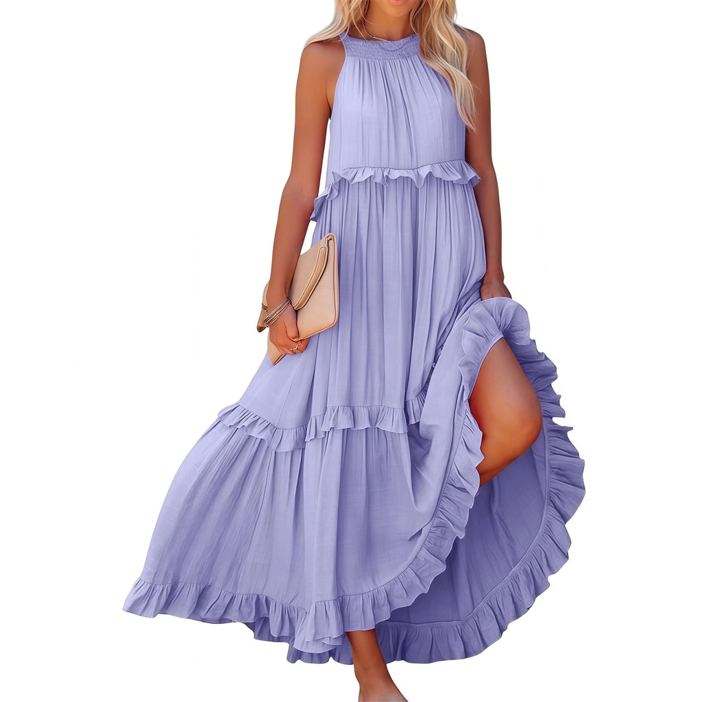 Woman wearing a purple halter neck dress with ruffles on a white background
