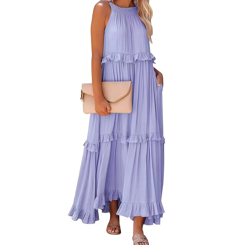 Woman wearing a purple ruffled dress holding a beige clutch on a white background